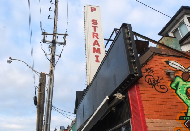 the first a in pastrami is missing, in a sign above a restaurant. 