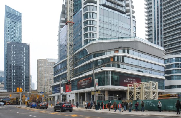 new condo tower under construction, pinnacle, large podium at first few floors