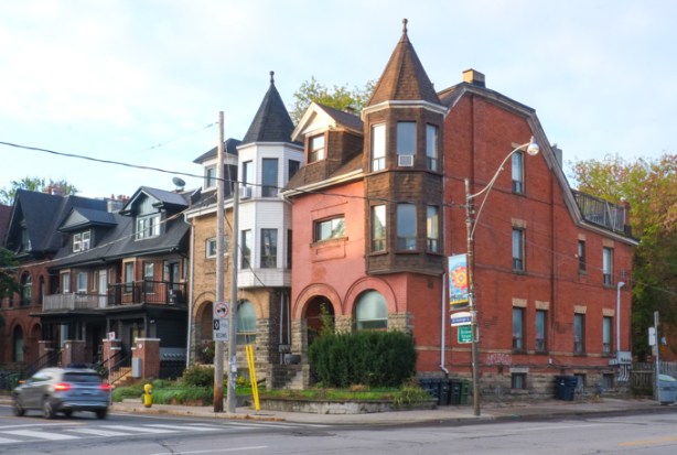 large multi unti old brick residence, three storeys, two turrets
