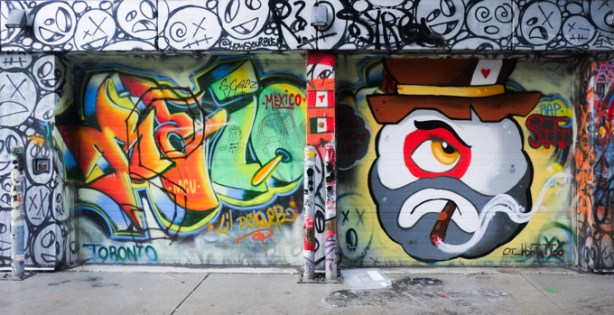 two garage door murals in graffiti alley