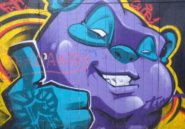 street art painting, graffiti alley, purple face, blue hands with thumbs up