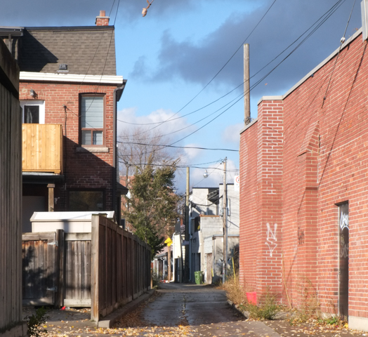 start of an alley that runs north from Edna Avenue, houses, garages, blue sky,