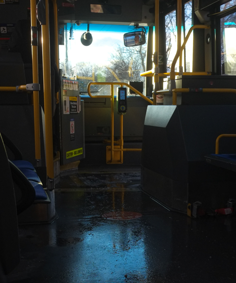 interior of bus, winter day, wet floor with reflected light