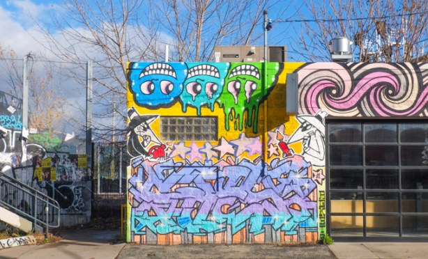 graffiti on building at bottom of stairs