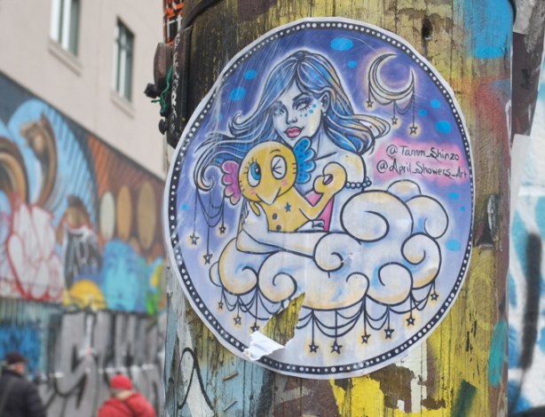 round paper paste up on a utility pole in Graffiti Alley, 