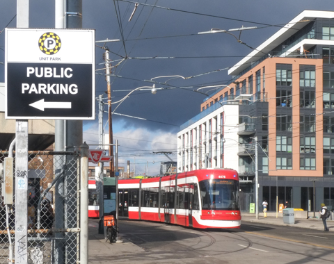 TTC streetcar pulling out f Dundas West station and onto street, intersection of Bloor and Dundas West