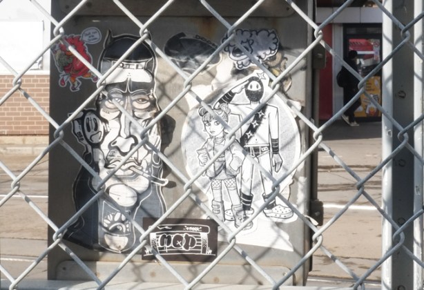 paste up graffiti, black ink on white paper, behind a chainlink fence beside a TTC subway station, Urban ninja squadron, visual noise,