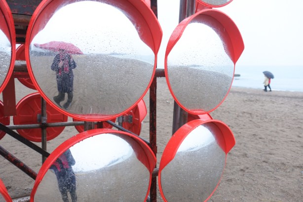 reflections in a group of convex circular mirrors, as part of an art installation called Chimera, at Woodbine Beach on Lake Ontario