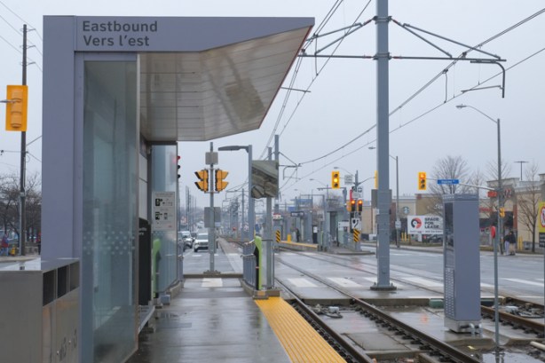 Eastbound Eglinton LRT train station in Scarborough, portion of line where tracks are above ground, Scarborough, rainy day, waiting for he streetcar