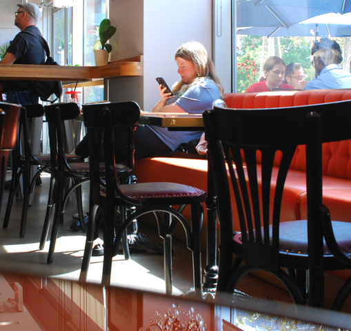 woman sitting in aroma coffee shop