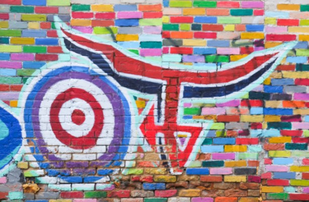 street art mural by thomas the anonymous in biscuit lane, including circular target with red bulls eye