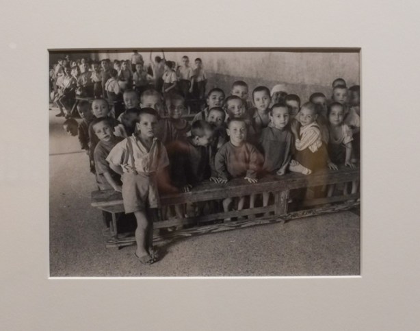 black and white photo by David Seymour, boys sitting on benches