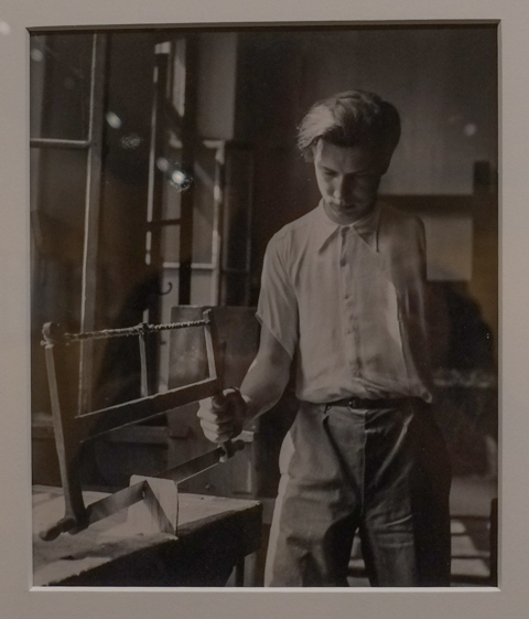 black and white photo by David Seymour, boy with only one arm learning to use a saw