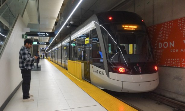 a man stands on the platform at Don Valley station waiting for an Eglinton LRT train