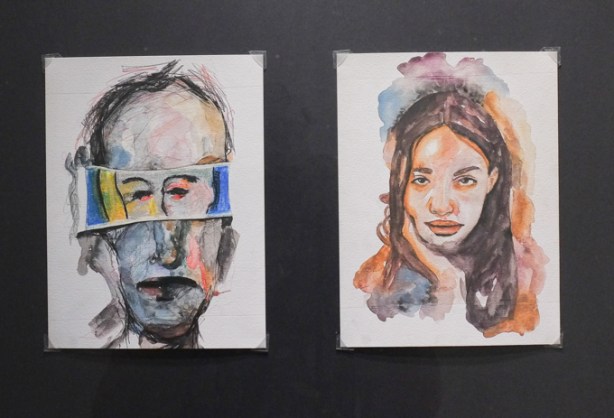 2 portraits, one male and one female, hanging in art gallery