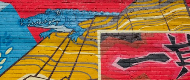 a portion of Japan Town 5 mural on the side of Sanko Trading Company store on Queen Street West, blue aligator