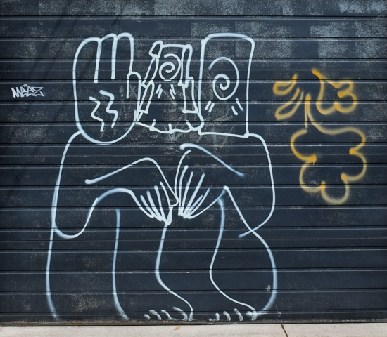 white line graffiti drawing on a black garage door