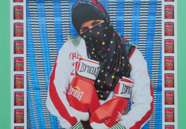 close up of an Arab woman with hair and face covered, wearing Everlast boxing gloves and jacket, photo by Hassan Hajjaj, CONTACT photography festival exhibit