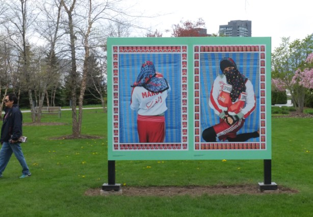  an Arab woman with hair and face covered, wearing Everlast boxing gloves and jacket, photo by Hassan Hajjaj, CONTACT photography festival exhibit, two panels, front view and back view of the woman