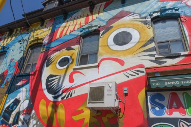 a portion of Japan Town 5 mural on the side of Sanko Trading Company store on Queen Street West, large cat face