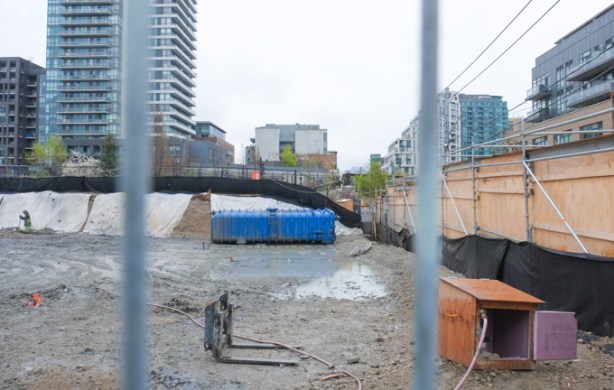 vacant lot, behind hoardings, buildings already demolished