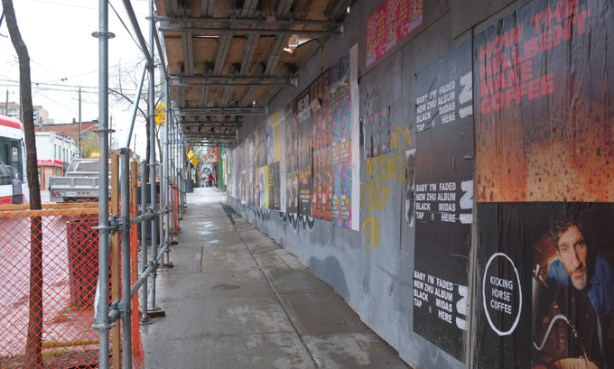 hoardings beside sidewalk on northwest part of queen and dufferin