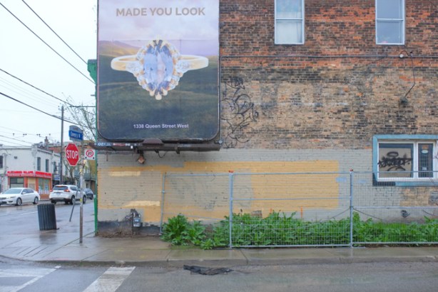 billboard on side of old brick building, with text that says made you look. it's an advertisement for a store of that name