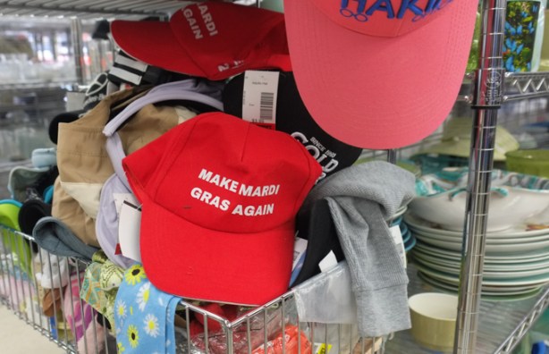 red baseball cap for sale in a thrift store, with words that say make mardi gras again