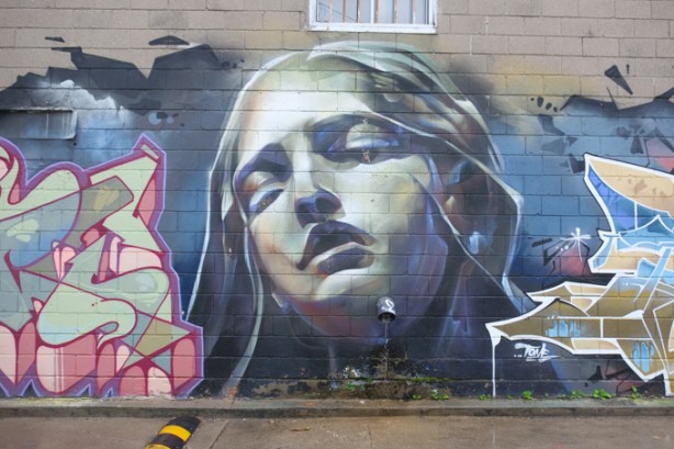 mural in Milky Way, grey tones, women's face, eyes closed