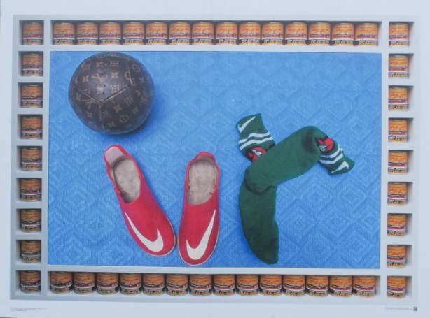 photo by Hassan Hajjaj, CONTACT photography festival exhibit, Aga Khan Park, Arab women boxers, photo of a black ball, a red pair of boxing shoes, and a dark green pair of socks