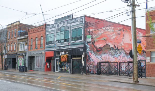 large street art mural on Queen west on side of building that is sound studio above and market below
