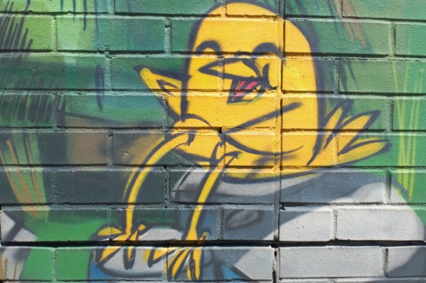 small part of animal themed mural by Uber 5000 at the Toronto Humane Society, little yellow birdie is laughing