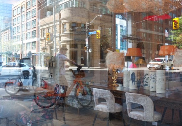cyclist, and king street reflected in a store window