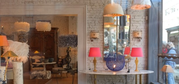 looking in window of a furniture store, with lamps, couches, mirrors, etc