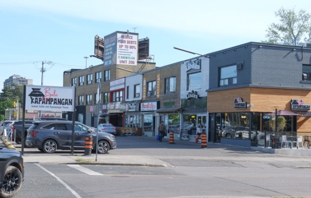 strip mall with small businesses, parking lot in front, 