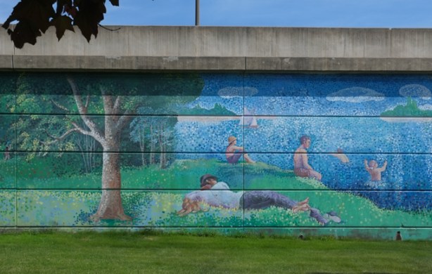 mural, painted in pointilism style, of beach scene, on wall of 401 overpass at Wilson and Bathurst