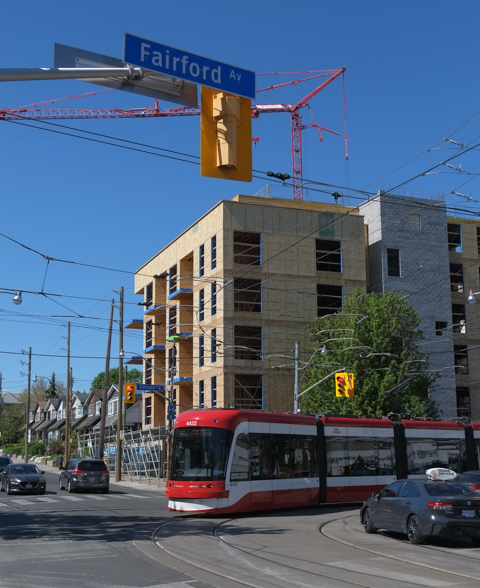new apartment building being built on northeast corner of Coxwell and Fairford, TTC streetcar in picture, Carleton Car.