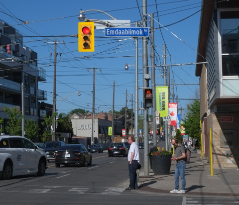 Emdaabiimok Ave city street sign, at Queen