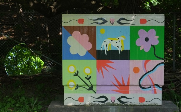 painted metal Bell telephone box beside a residential street