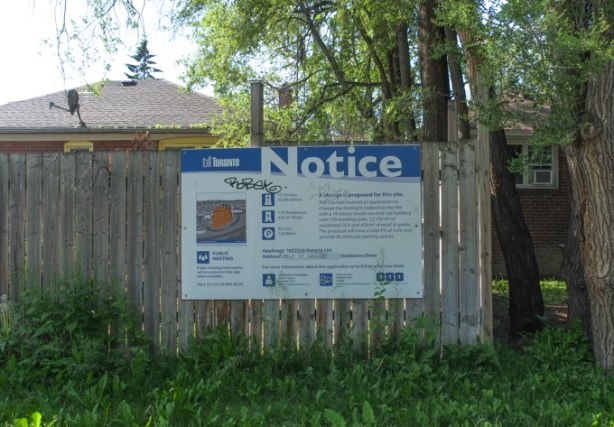 redevelopment notice on wood fence in front of a house on Richelieu Road