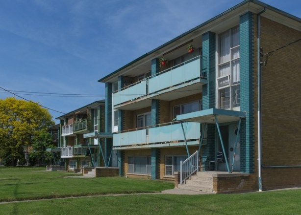 Sixplex residential building with balconies across the front, side angle