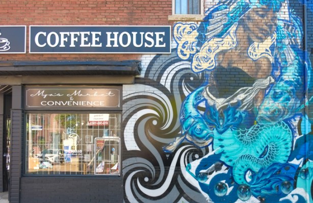 mural by Rowell Soller and Flips on brick wall outside of Coffee House on queen Street East