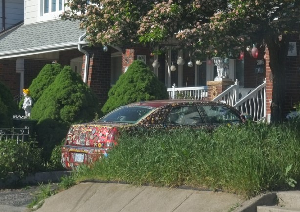 reddish colour car covered with sparkly bits as decoration