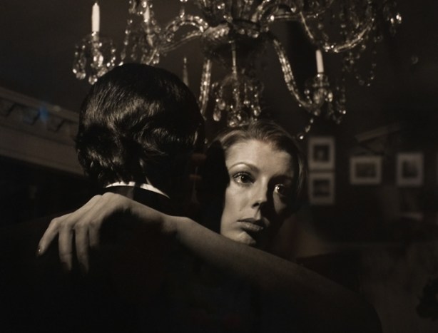 black and white photo by Larry Fink from his Social Graces series from the 1970s, couple dancing, under a chandelier, woman looking off into the distance