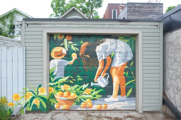 golden butter murals painting on garage on dundas east, mother and child working in the garden