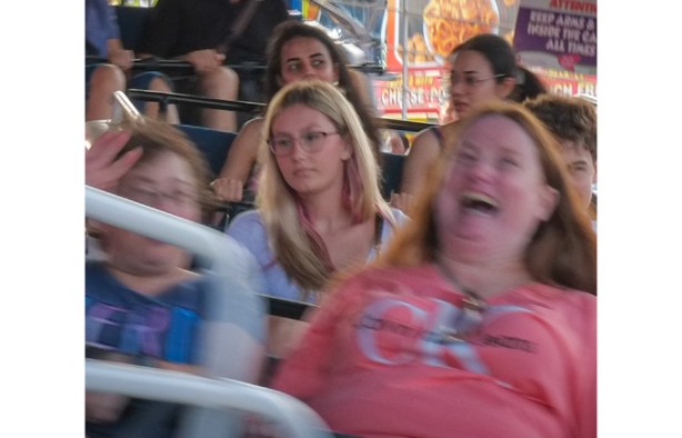 people on midway ride at the ex, some totally calm and some screaming