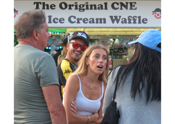 expressions on face, man in red sunglasses, people talking in front of the original CNE ice cream waffle sandwiches