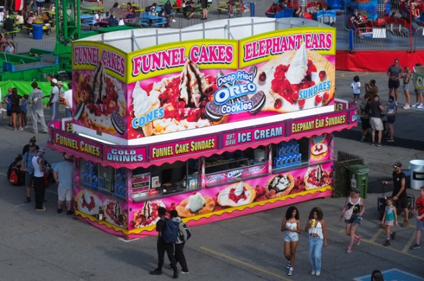 large CNE food concession stand (or building) selling funnel cakes, deep fried oreo cookies, elephant ears sundaes, funnel cake sundaes,