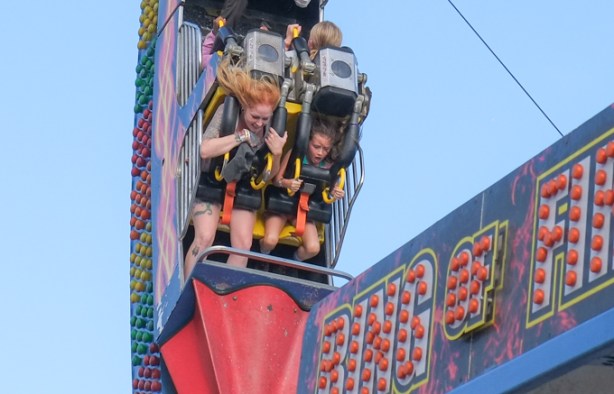 mother and daughter screaming on a ride called ring of fire, Canadian National Exhibition, midway, a tall tower swing amusement ride, or high-flying swing ride,