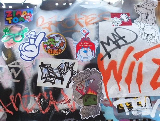 graffiti stickers and slaps on a wall